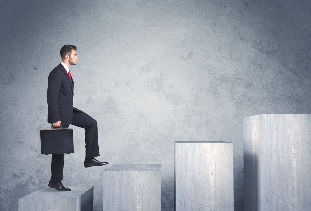 Business person stepping up a staircase