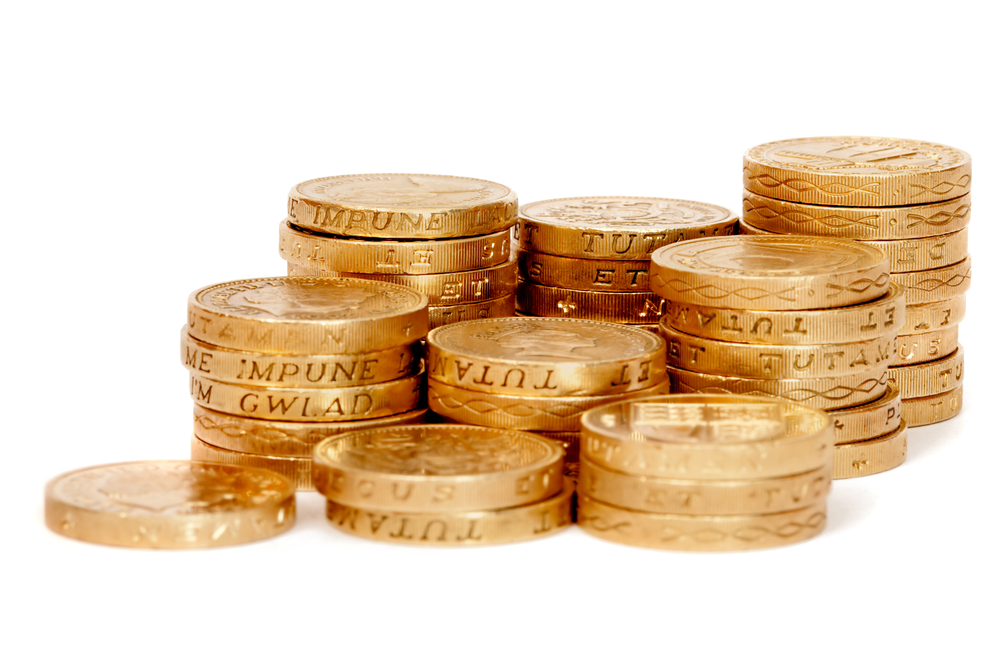 Pile of coins in a row isolated over a white background