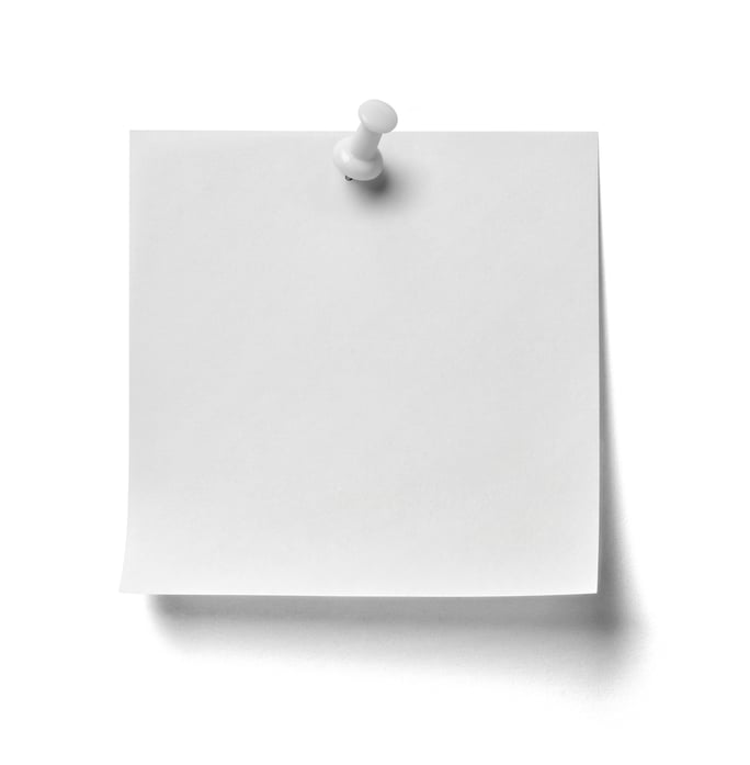 close up of  a note paper with a red push pin on white background