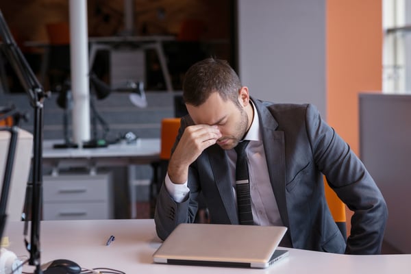 frustrated young business man working on laptop computer at office-1