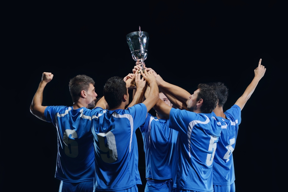 soccer players team group celebrating the victory and become champion of game while holding win coup